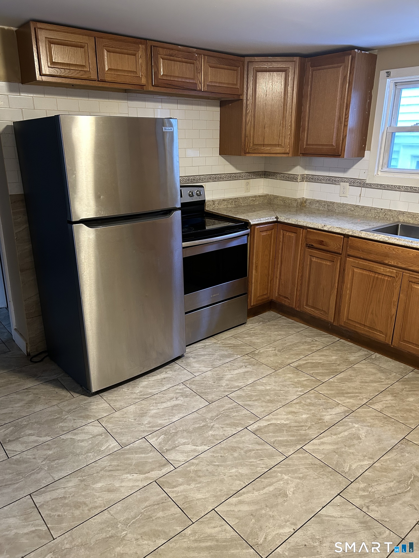240 Scott Street Naugatuck, CT 06770 - Photo 1 of 10 a kitchen with stainless steel appliances granite countertop a refrigerator sink and cabinets