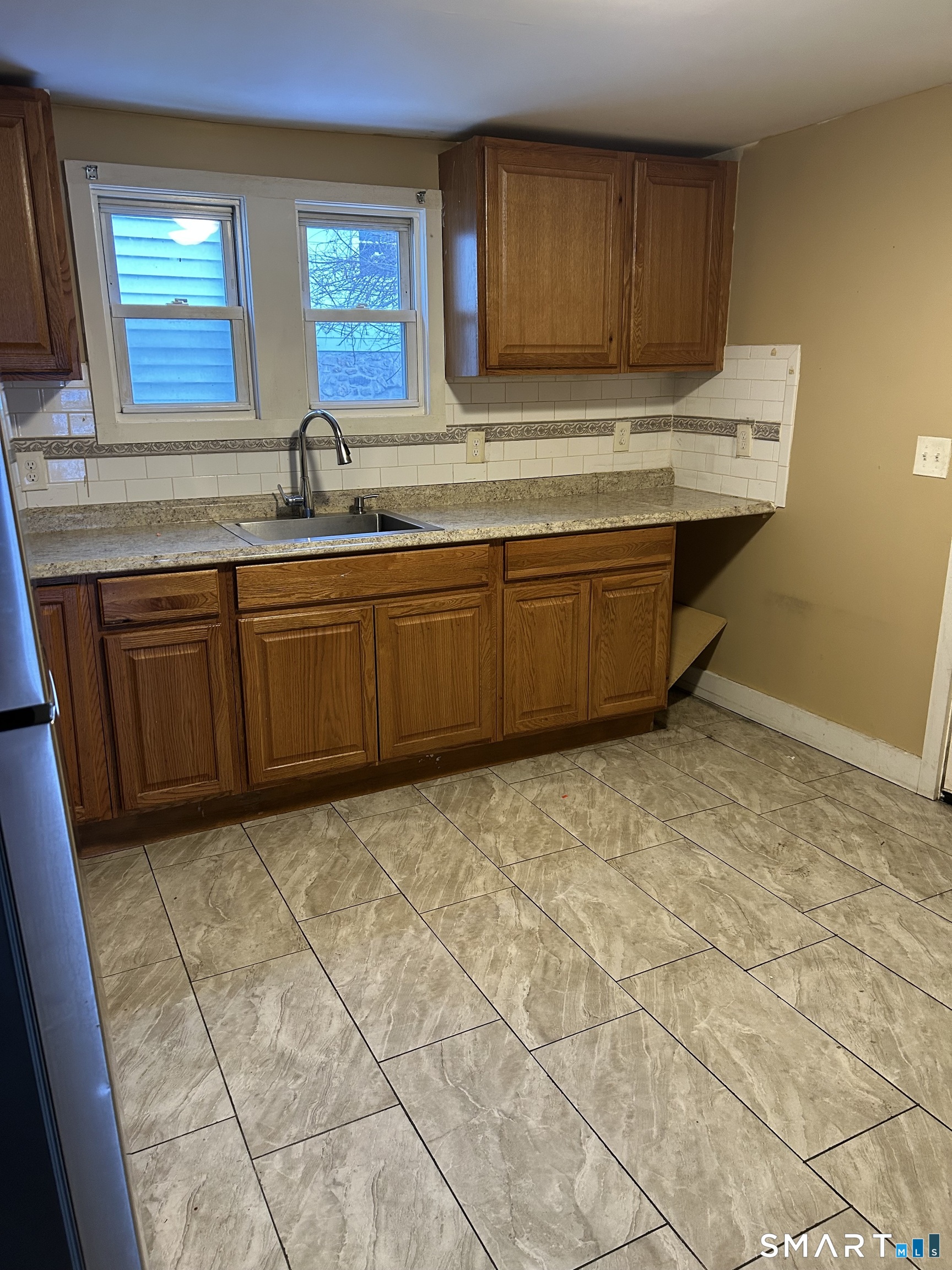 240 Scott Street Naugatuck, CT 06770 - Photo 2 of 10 a kitchen with granite countertop a sink a stove a cabinets and a window