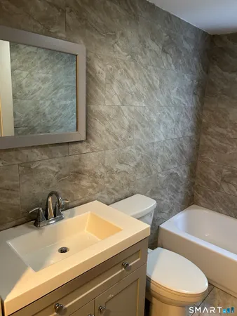 a bathroom with a sink a toilet and bathtub