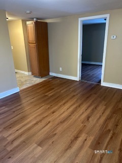 240 Scott Street Naugatuck, CT 06770 - Photo 6 of 10 a view of an empty room with wooden floor and a window
