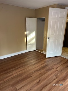 240 Scott Street Naugatuck, CT 06770 - Photo 8 of 10 an empty room with wooden floor and windows