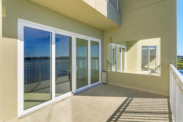 a bedroom with a bed and glass door