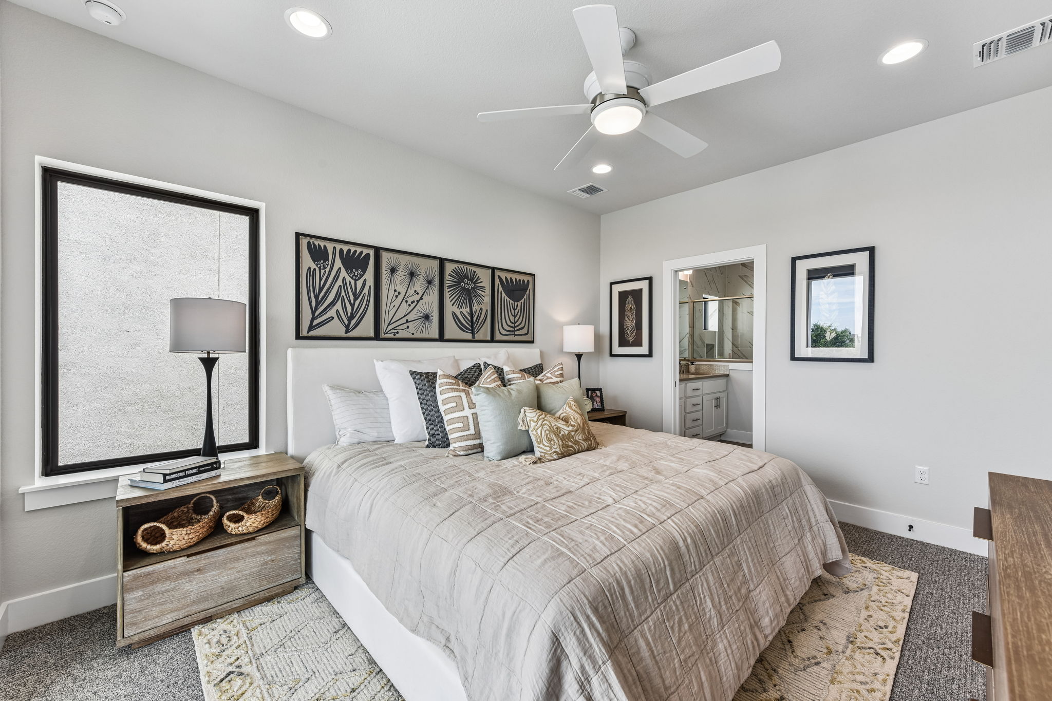9101 Cattle Baron Path Austin, TX 78747 - Photo 22 of 40 Well-lit sleeping quarters with a ceiling fan, plush carpeting, and access to a private bath.