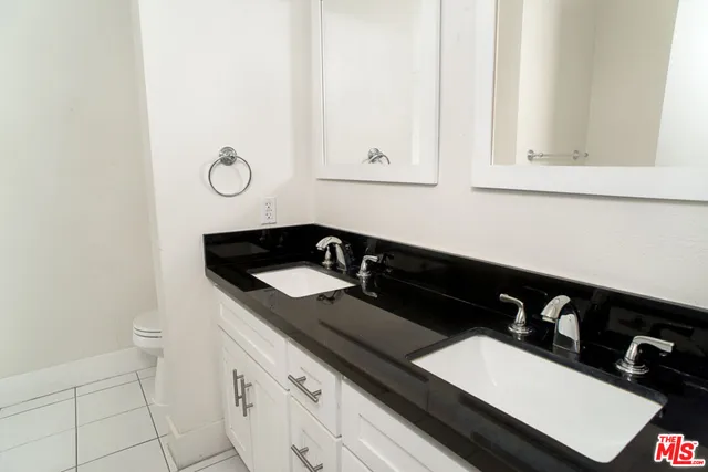 a view of a sink and a microwave in a white cabinet