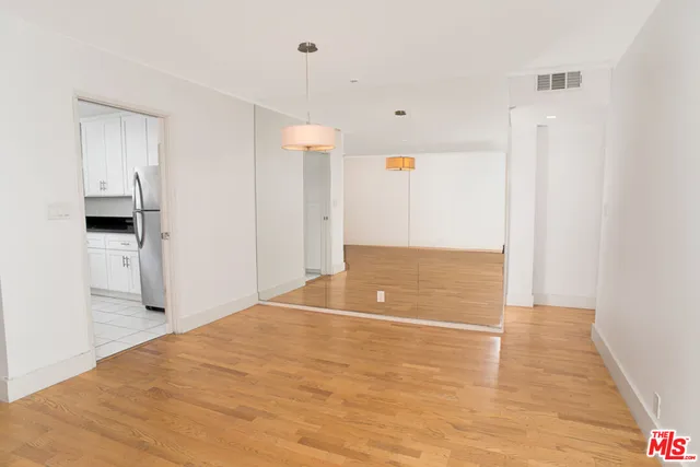 a kitchen with granite countertop white cabinets and sink