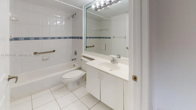 a bathroom with a toilet a sink a mirror a shower and vanity