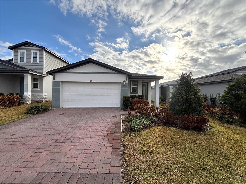 828 Rivers Crossing Street Clermont, FL 34714 - Photo 1 of 17 a front view of house with yard and trees around