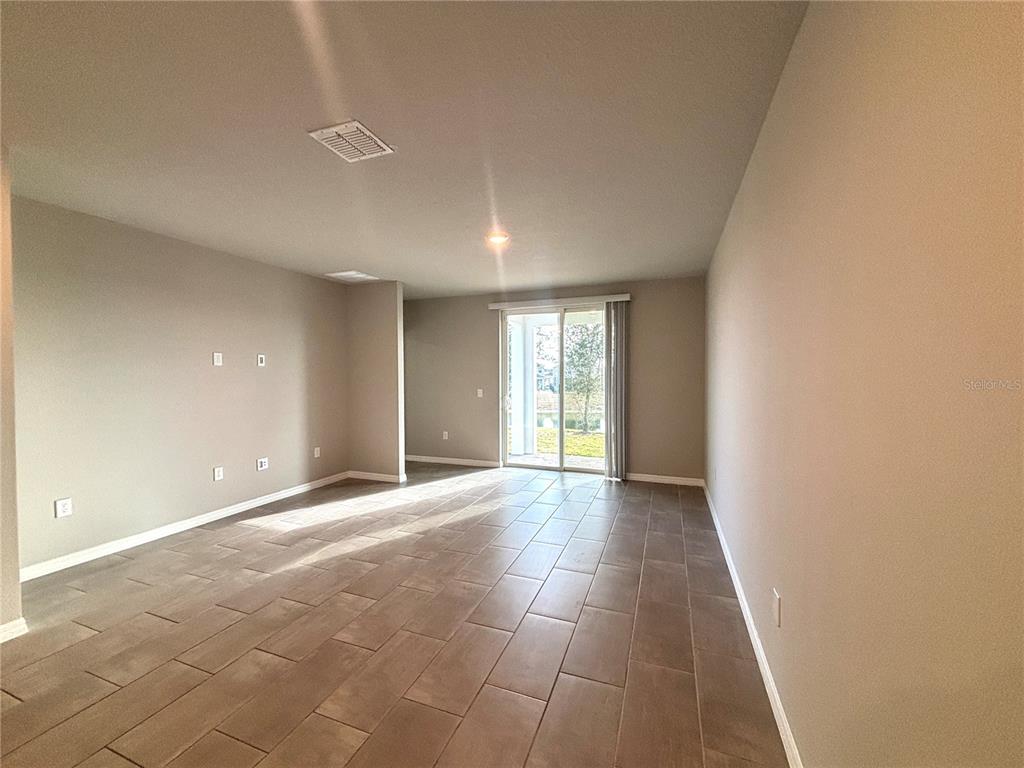 828 Rivers Crossing Street Clermont, FL 34714 - Photo 4 of 17 a view of an empty room with a window