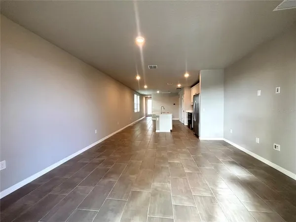 a view of a hallway with a kitchen
