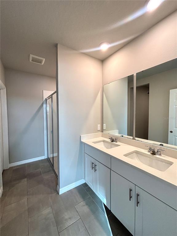 828 Rivers Crossing Street Clermont, FL 34714 - Photo 8 of 17 a bathroom with a granite countertop sink and a mirror