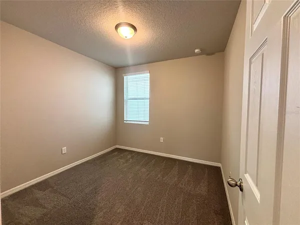 an empty room with a empty space and windows