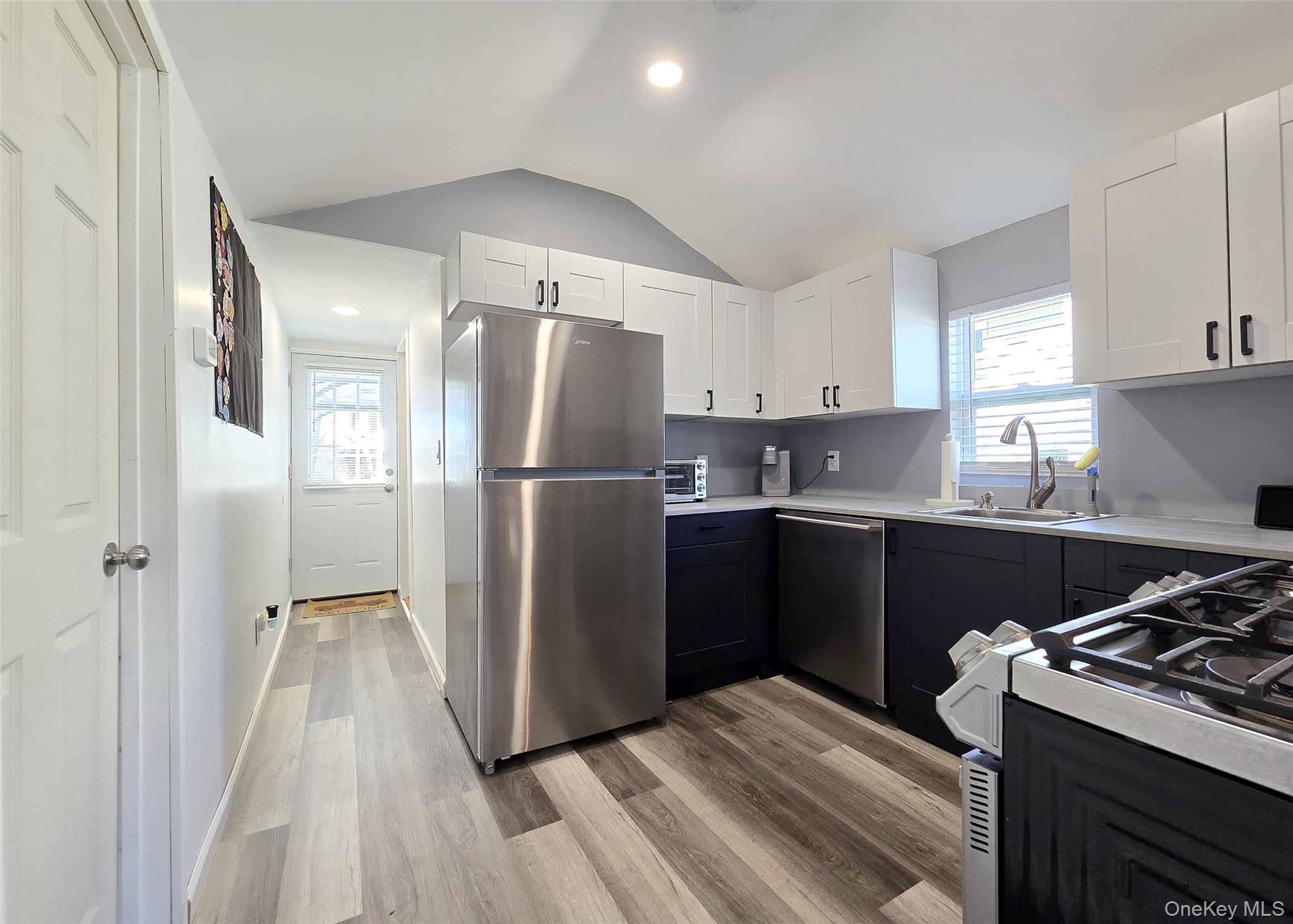 20 Daisy Place Selden, NY 11784 - Photo 5 of 13 a kitchen with a refrigerator sink and cabinets