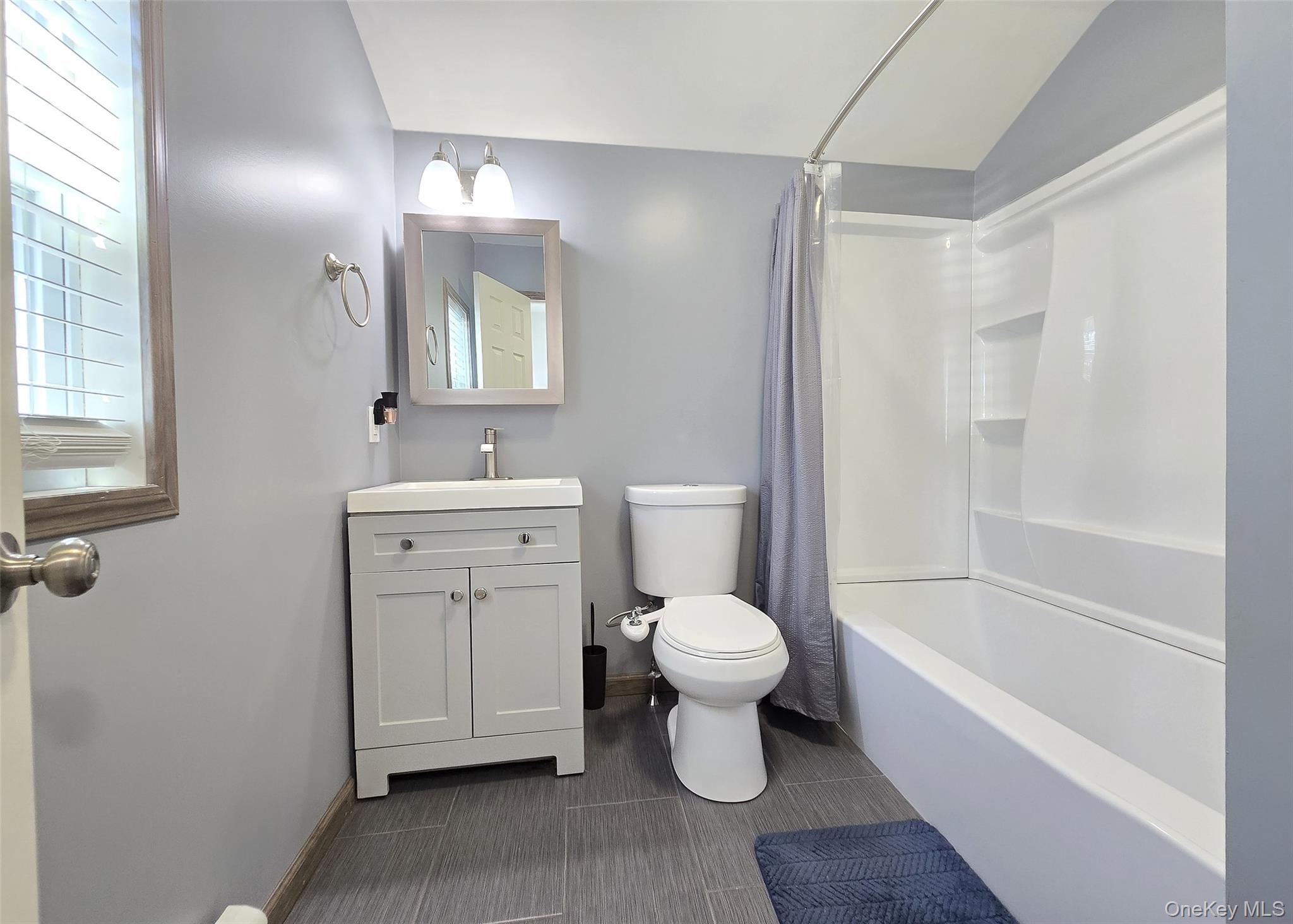 20 Daisy Place Selden, NY 11784 - Photo 6 of 13 a bathroom with a sink toilet a mirror and shower