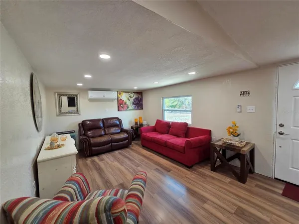 a living room with furniture and a baby crib
