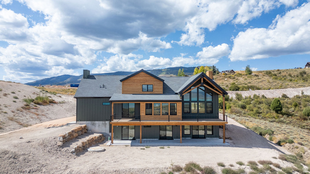 300 Knoll Loop, Unit 227 Fish Haven, ID 83287 - Photo 51 of 56 Rear view of house with a mountain view, a chimney, a sunroom, and a patio area