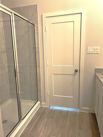 a bathroom with a glass shower door