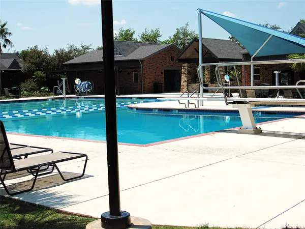a view of a swimming pool with a patio