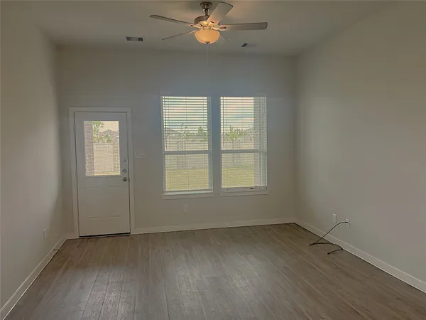 wooden floor in an empty room with a window