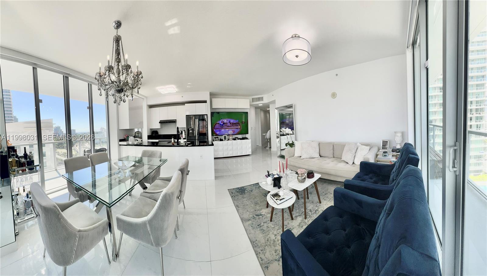 79 Southwest 12th Street, Unit 1806 Miami, FL 33130 - Photo 6 of 44 a view of a dining room with furniture a chandelier and large windows
