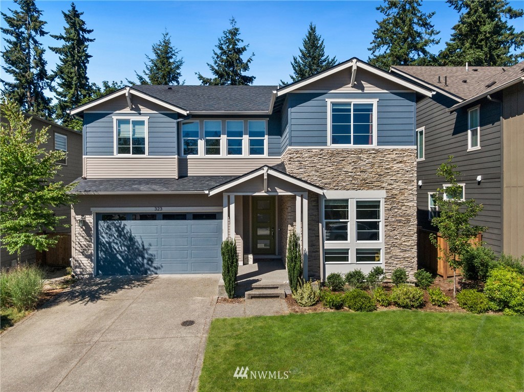 a front view of a house with a garden and plants