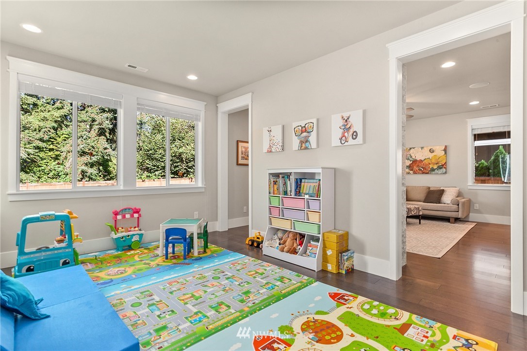 323 Field Place Southeast Renton, WA 98059 - Photo 17 of 40 a bedroom with furniture and a book shelf