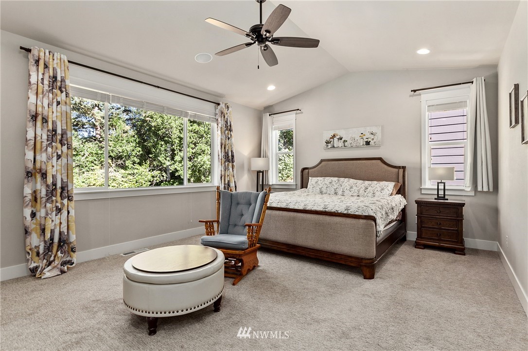 323 Field Place Southeast Renton, WA 98059 - Photo 19 of 40 a spacious bedroom with a bed and a chandelier