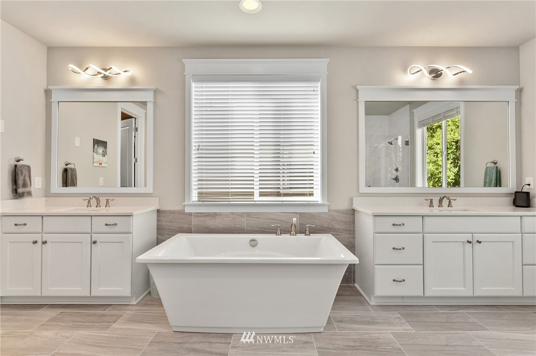323 Field Place Southeast Renton, WA 98059 - Photo 21 of 40 a spacious bathroom with a tub sink and mirror