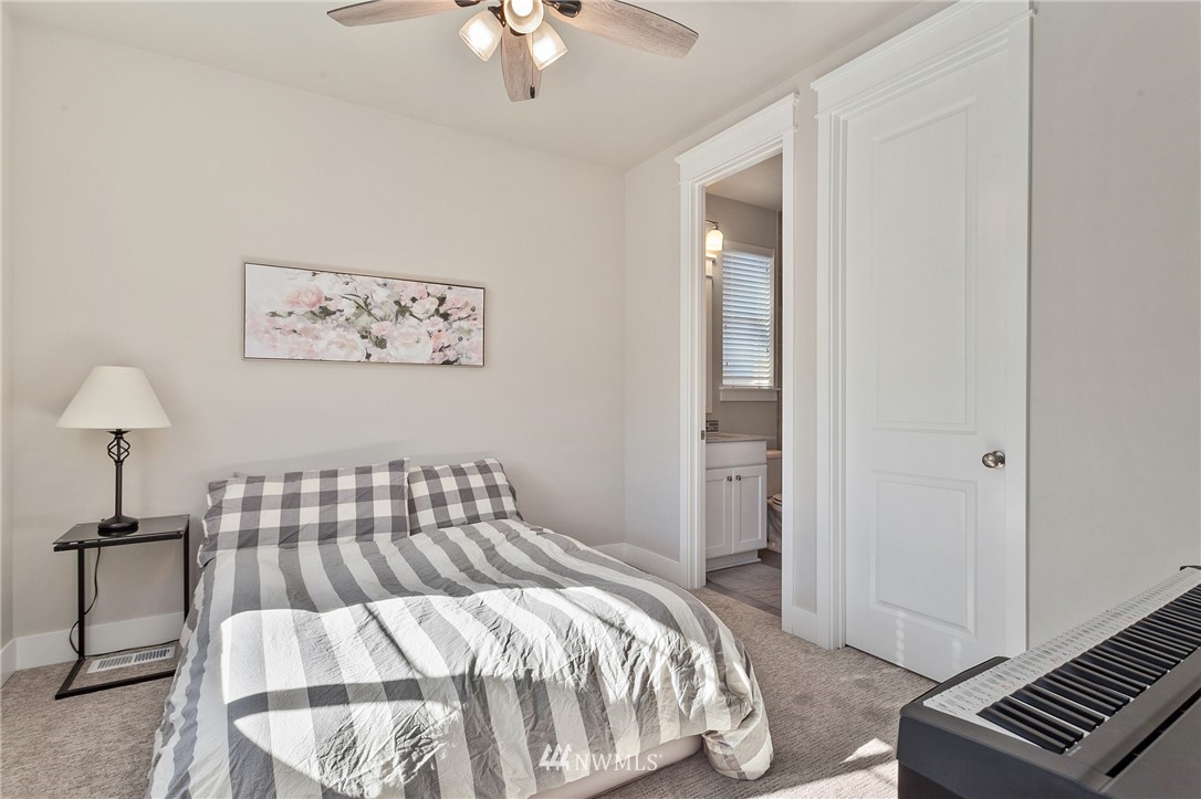 323 Field Place Southeast Renton, WA 98059 - Photo 26 of 40 a bedroom with a bed and a lamp on dresser