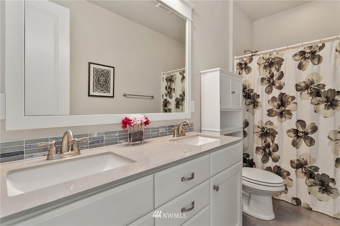 323 Field Place Southeast Renton, WA 98059 - Photo 30 of 40 a bathroom with a sink and a mirror
