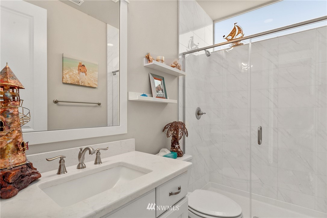 323 Field Place Southeast Renton, WA 98059 - Photo 34 of 40 a bathroom with a sink mirror vanity and toilet