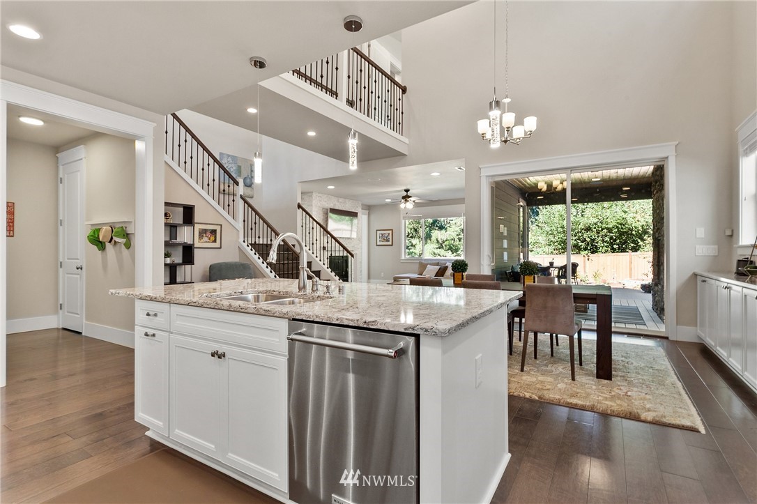 323 Field Place Southeast Renton, WA 98059 - Photo 6 of 40 a kitchen with granite countertop a counter space a sink appliances and a large window