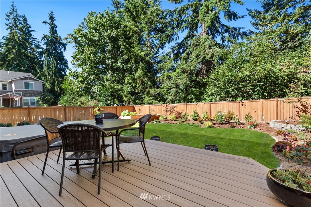 323 Field Place Southeast Renton, WA 98059 - Photo 9 of 40 a view of a patio with table and chairs with wooden floor and plants