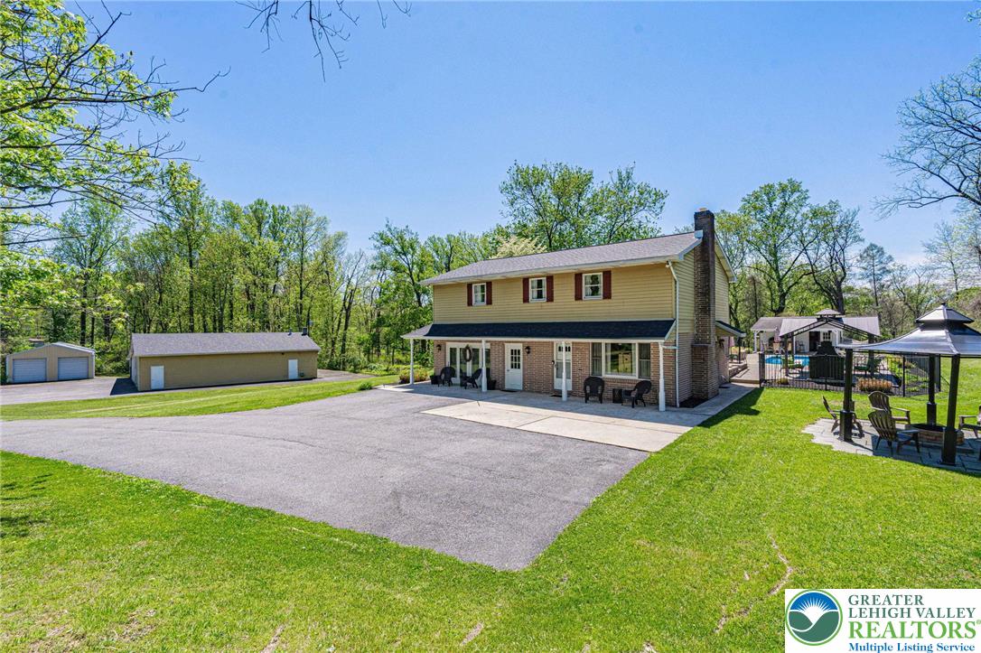 3857 Friedens Road Slatington, PA 18080 - Photo 2 of 75 This expansive estate offers a welcoming facade, generous parking, and a delightful outdoor oasis.