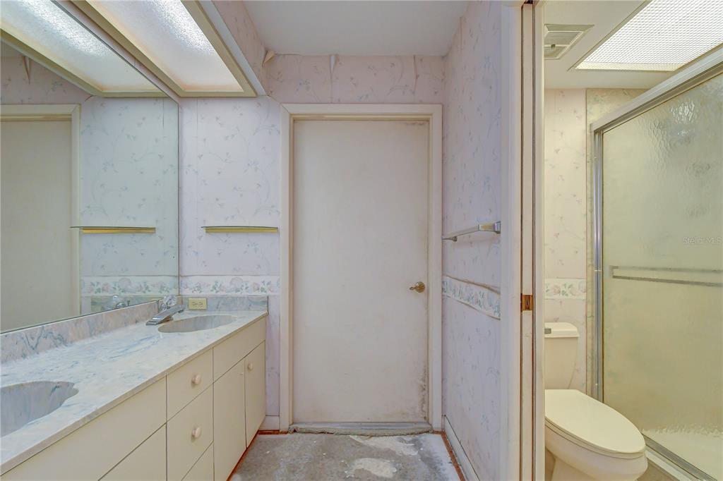914 South Miller Road Valrico, FL 33594 - Photo 25 of 51 a bathroom with a granite countertop sink toilet and shower