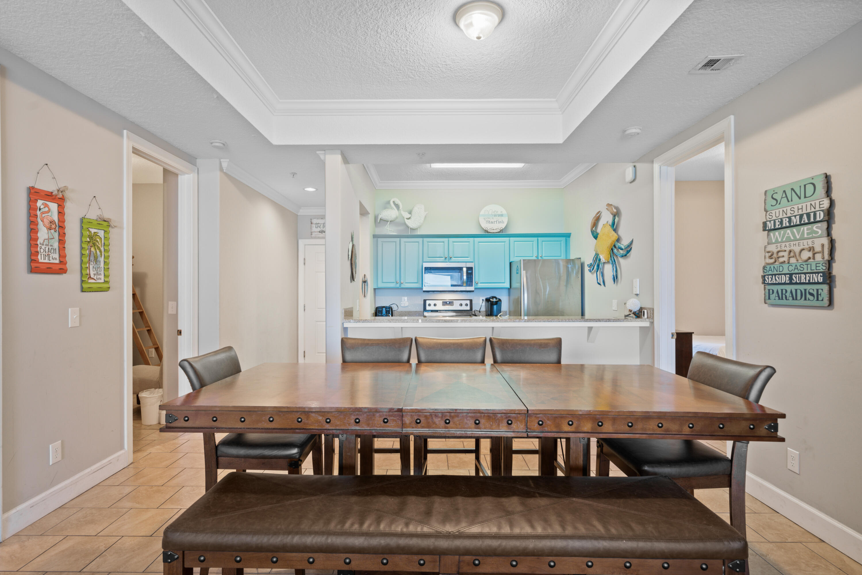 10611 Front Beach Road, Unit 2001 Panama City Beach, FL 32408 - Photo 12 of 49 a dining hall with stainless steel appliances granite countertop a stove and a dining table with wooden floor