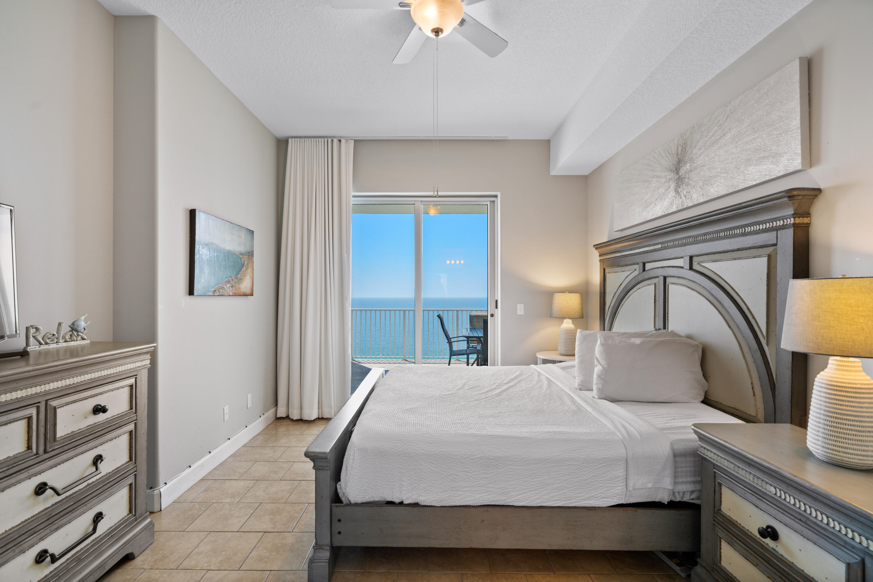 10611 Front Beach Road, Unit 2001 Panama City Beach, FL 32408 - Photo 20 of 49 a bedroom with a bed and a chandelier