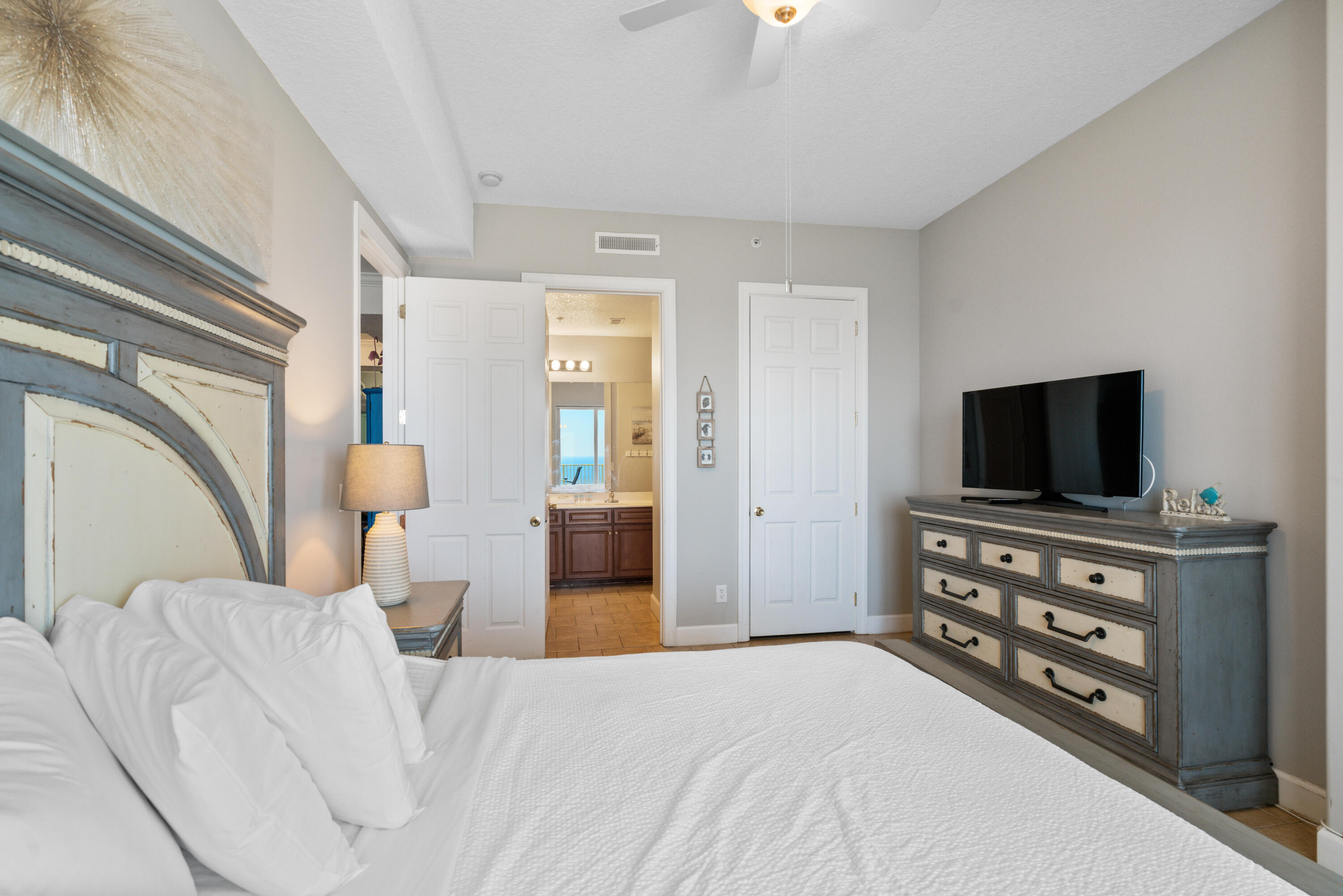 10611 Front Beach Road, Unit 2001 Panama City Beach, FL 32408 - Photo 21 of 49 a bedroom with a bed and a flat screen tv