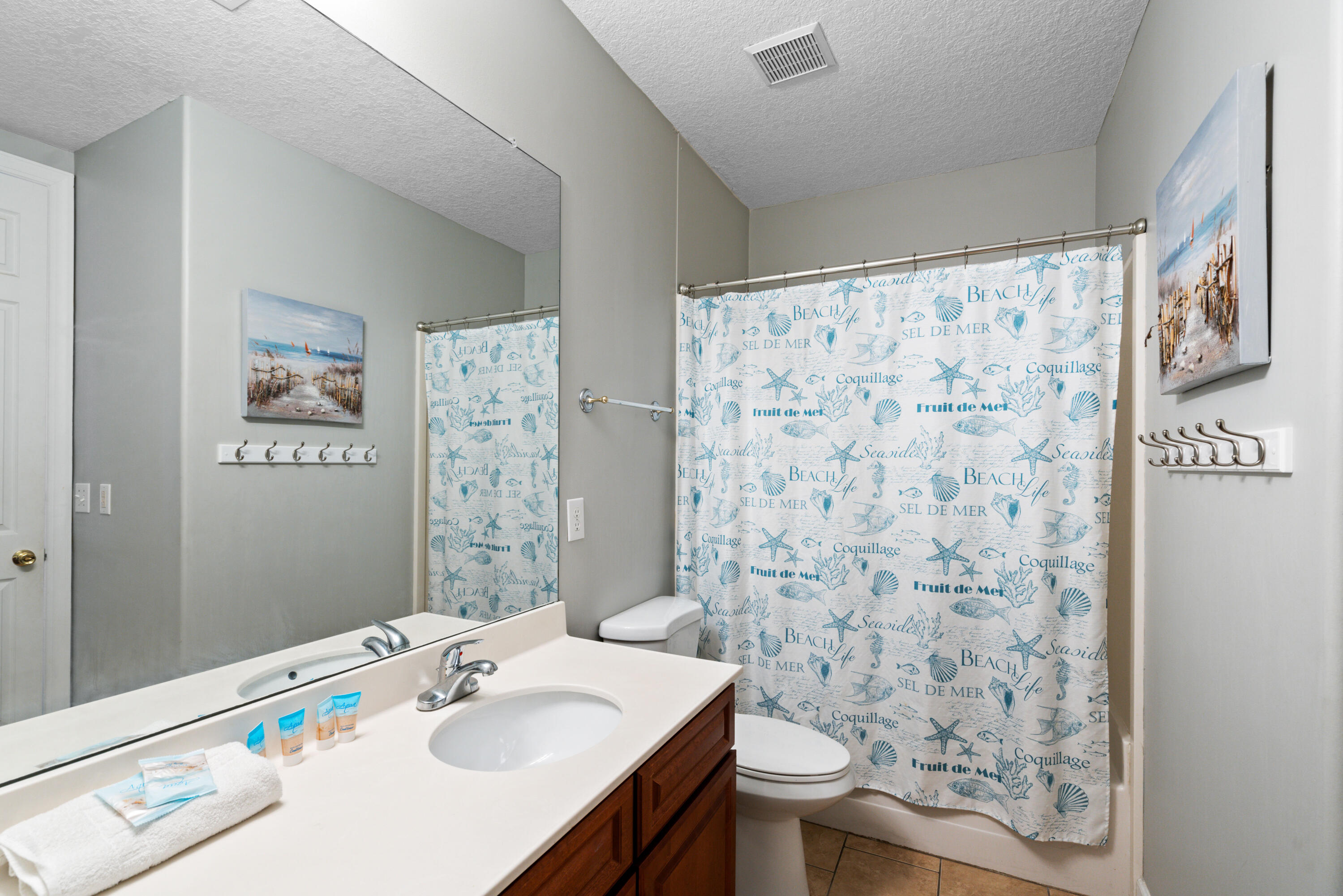 10611 Front Beach Road, Unit 2001 Panama City Beach, FL 32408 - Photo 23 of 49 a bathroom with a sink toilet and shower