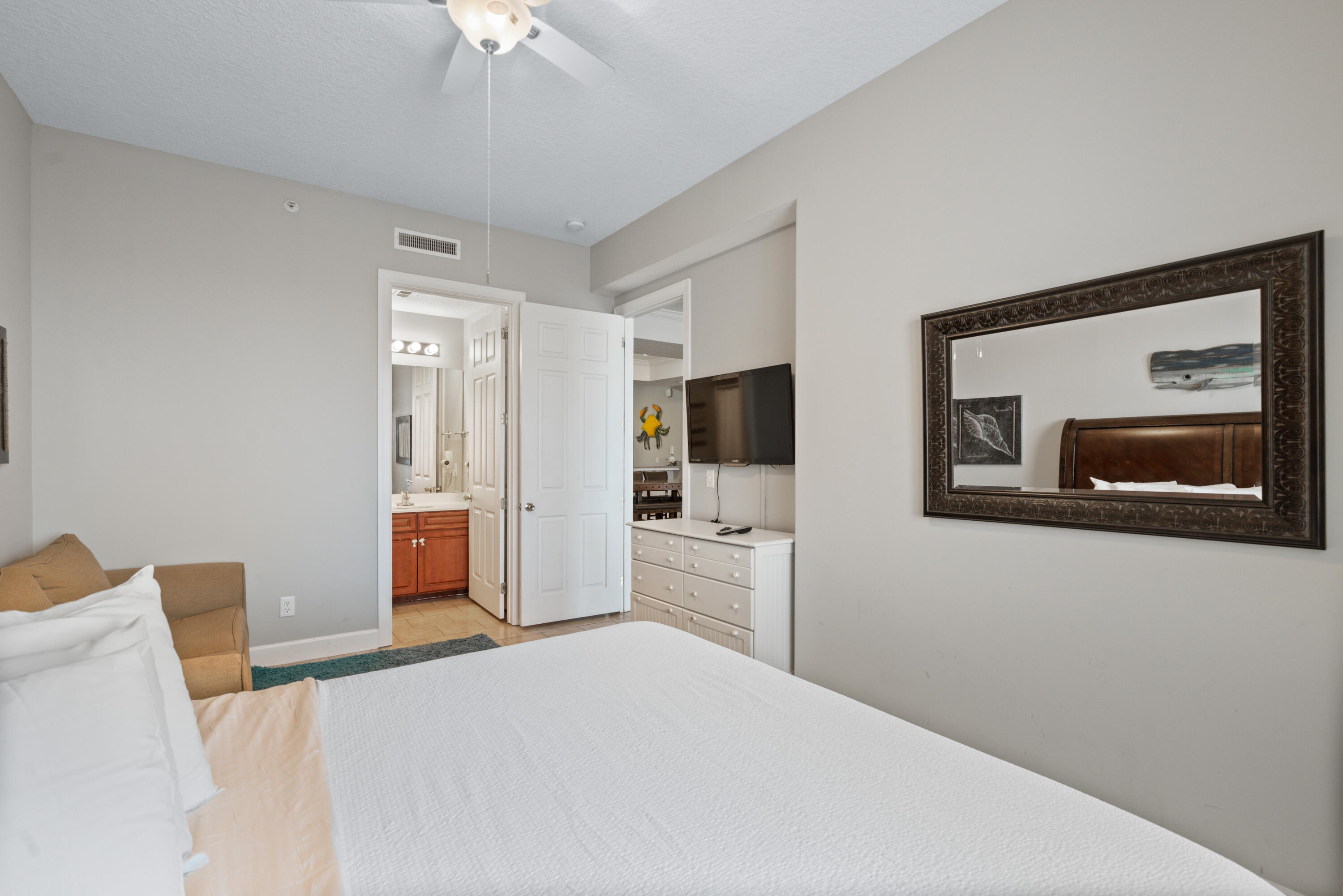 10611 Front Beach Road, Unit 2001 Panama City Beach, FL 32408 - Photo 28 of 49 a bedroom with a bed and a flat screen tv