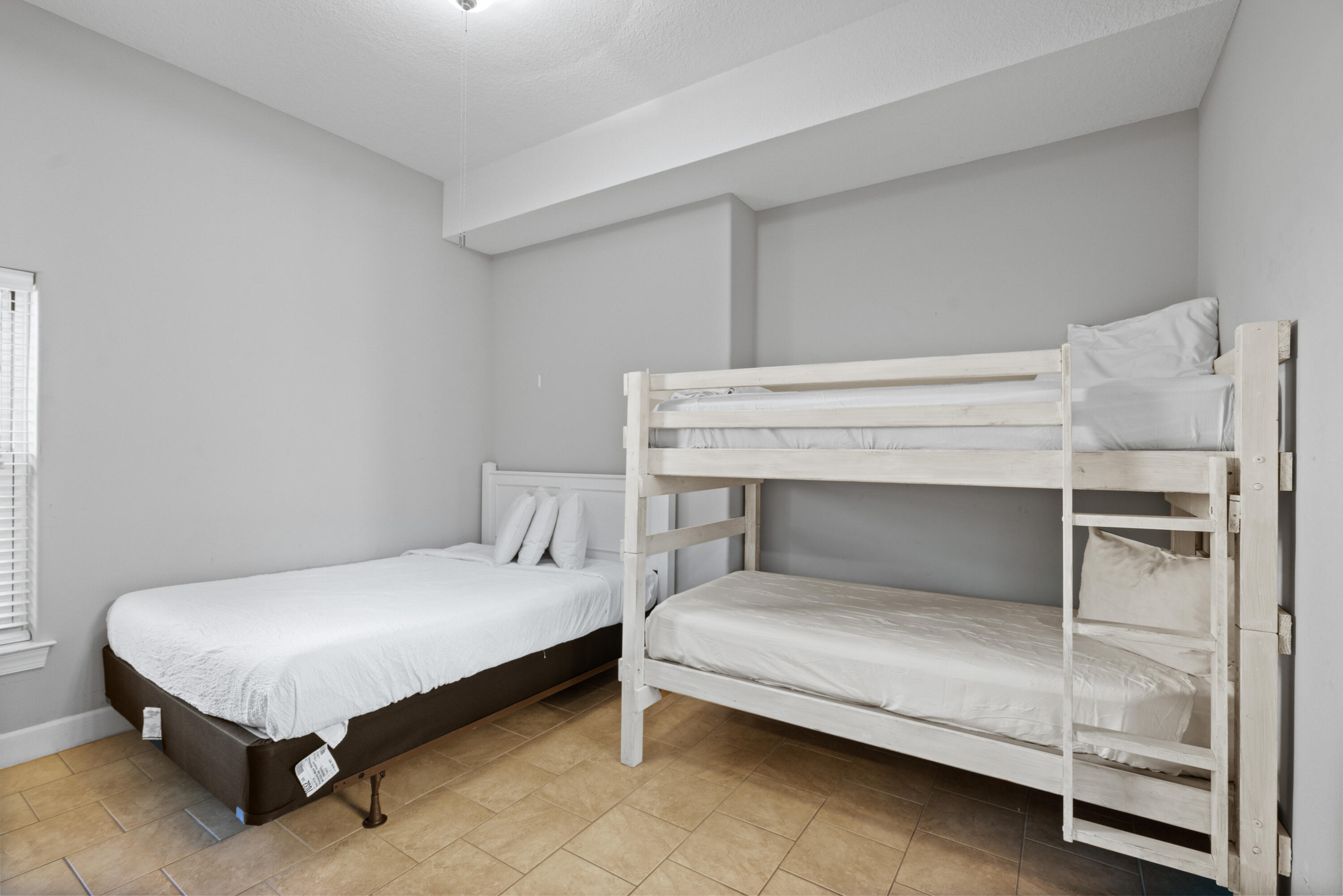 10611 Front Beach Road, Unit 2001 Panama City Beach, FL 32408 - Photo 34 of 49 a bedroom with a bed and a table