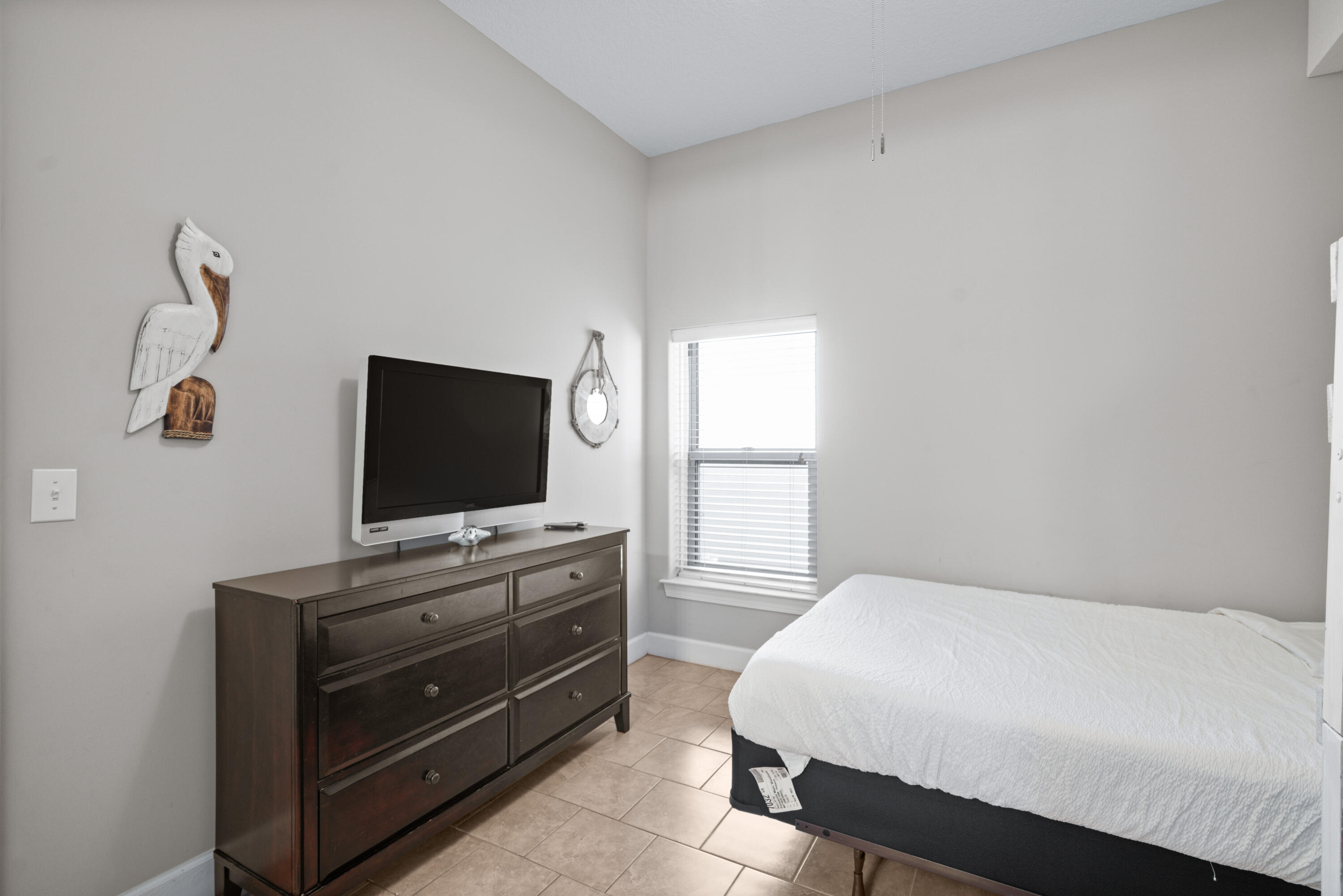 10611 Front Beach Road, Unit 2001 Panama City Beach, FL 32408 - Photo 35 of 49 a bedroom with a bed and a flat screen tv