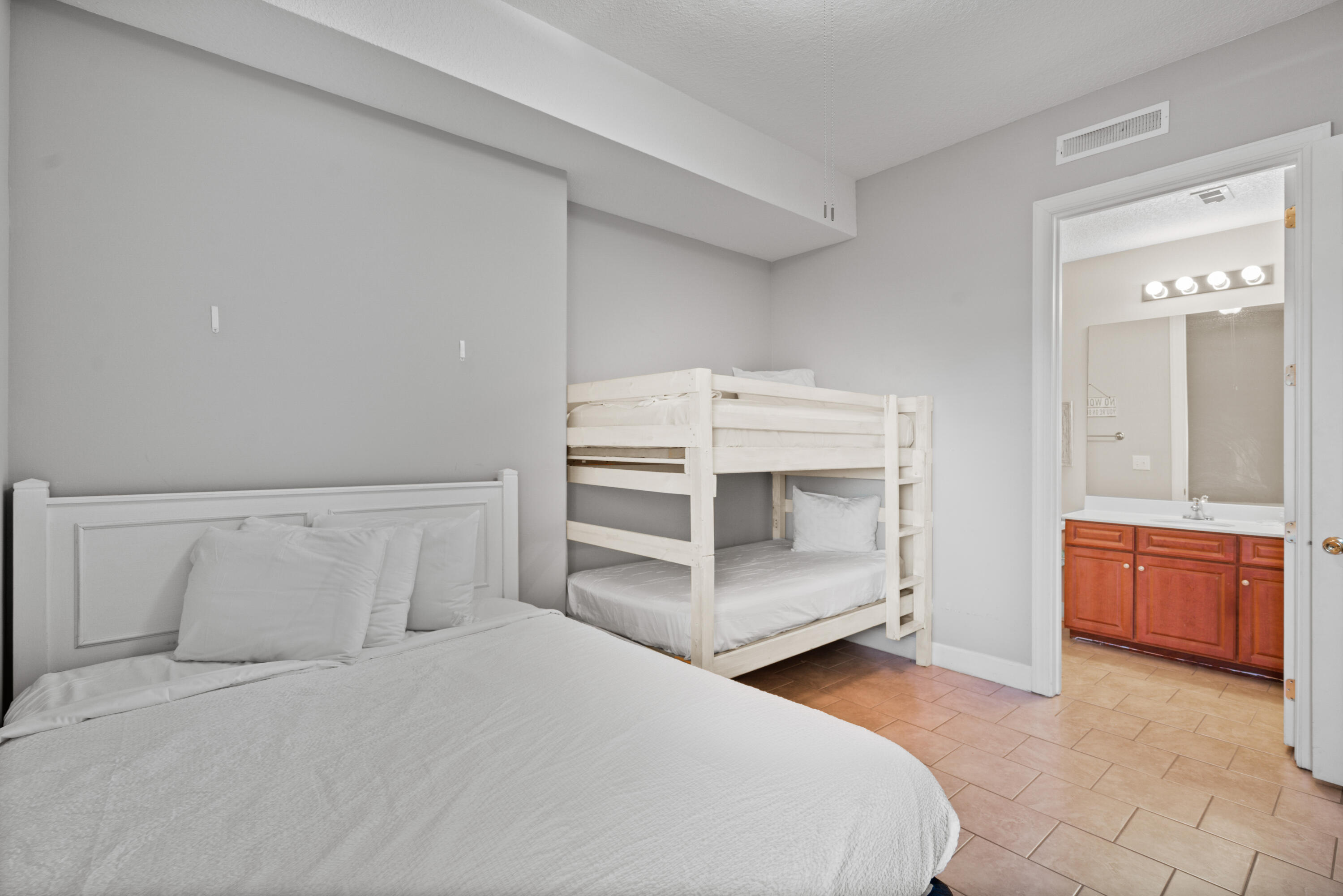 10611 Front Beach Road, Unit 2001 Panama City Beach, FL 32408 - Photo 36 of 49 a bedroom with a bed and a dresser