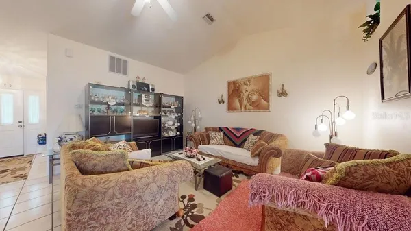 a living room with furniture and a flat screen tv