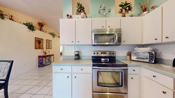 a kitchen with stainless steel appliances a stove a microwave and cabinets