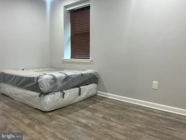 a spacious bedroom with a bed and a window