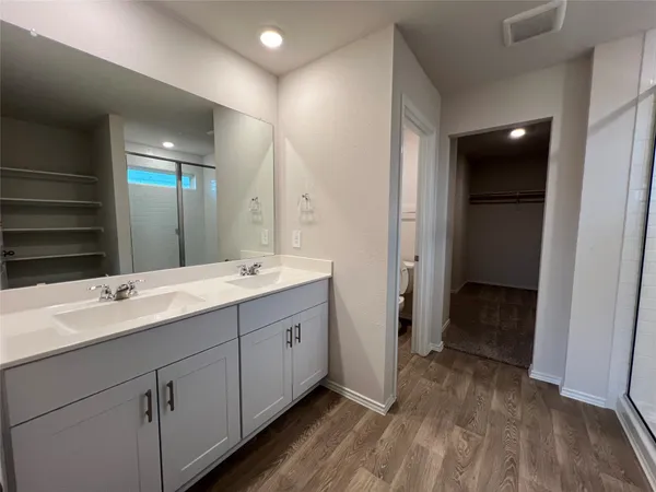 a bathroom with a glass shower door