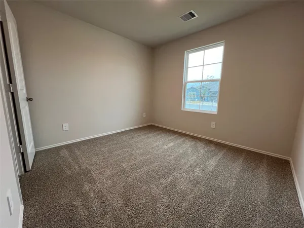 a view of an empty room and closet area