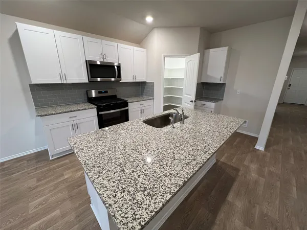 a view of washer and dryer with wooden floor