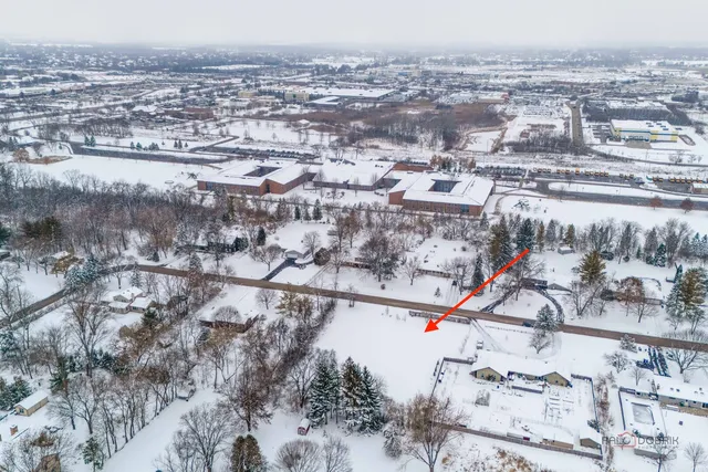 a view of staircase with white walls and railing