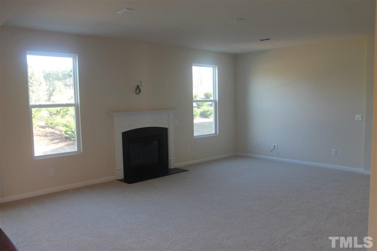 104 Hope Valley Road Knightdale, NC 27545 - Photo 7 of 15 an empty room with windows and fireplace